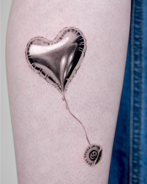 2026 tattoo trends microrealism chrome balloon tattoo on arm